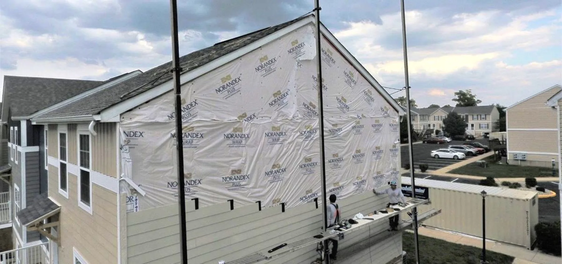 Kingdom Konstruction crew installing exterior siding on a multi-family building in Texas