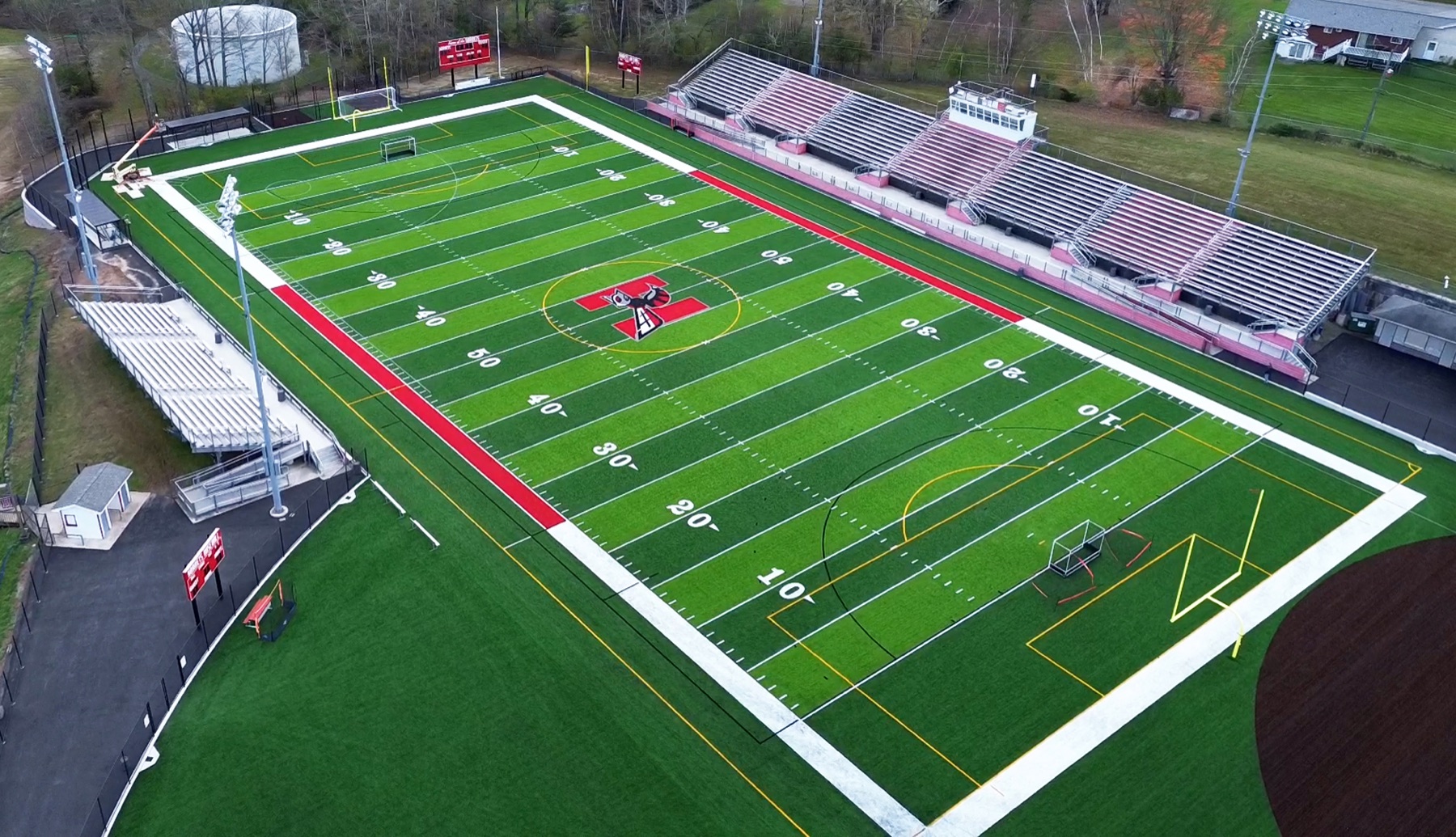 Aerial of a Kingdom Konstruction-built artificial turf football field with stadium bleachers in Texas