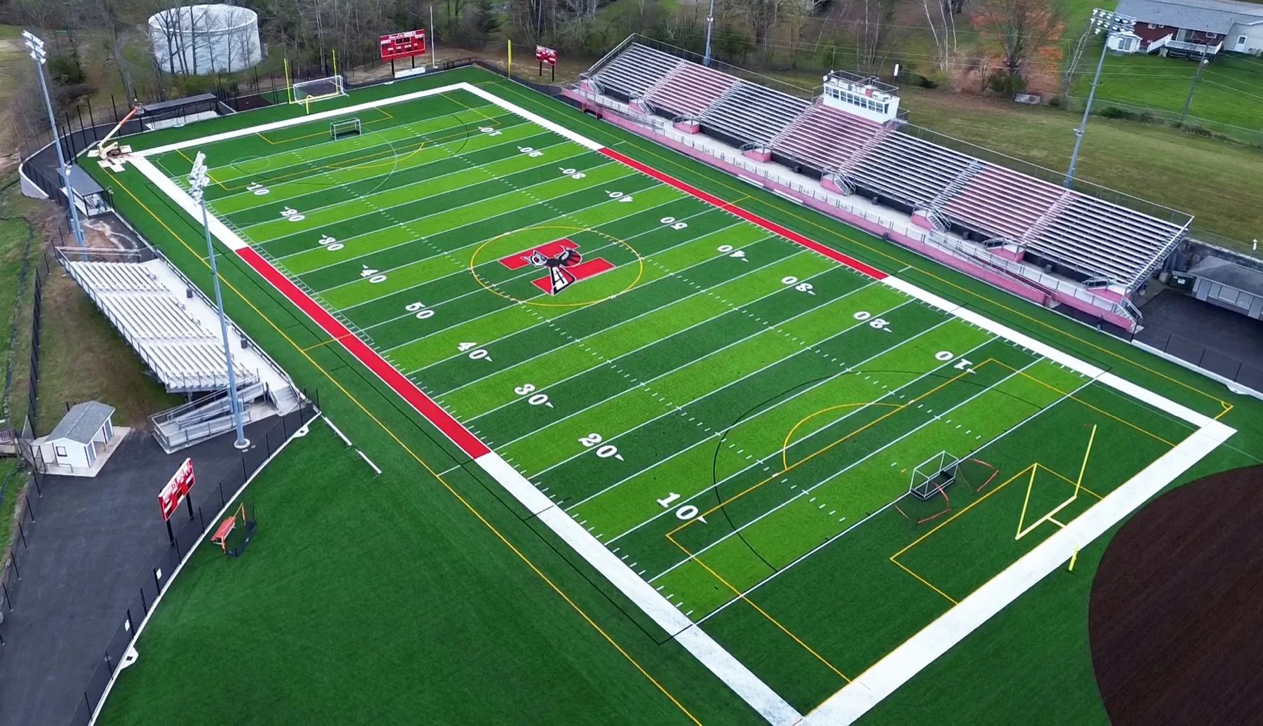 Aerial of a Kingdom Konstruction-built artificial turf football field with stadium bleachers in Texas