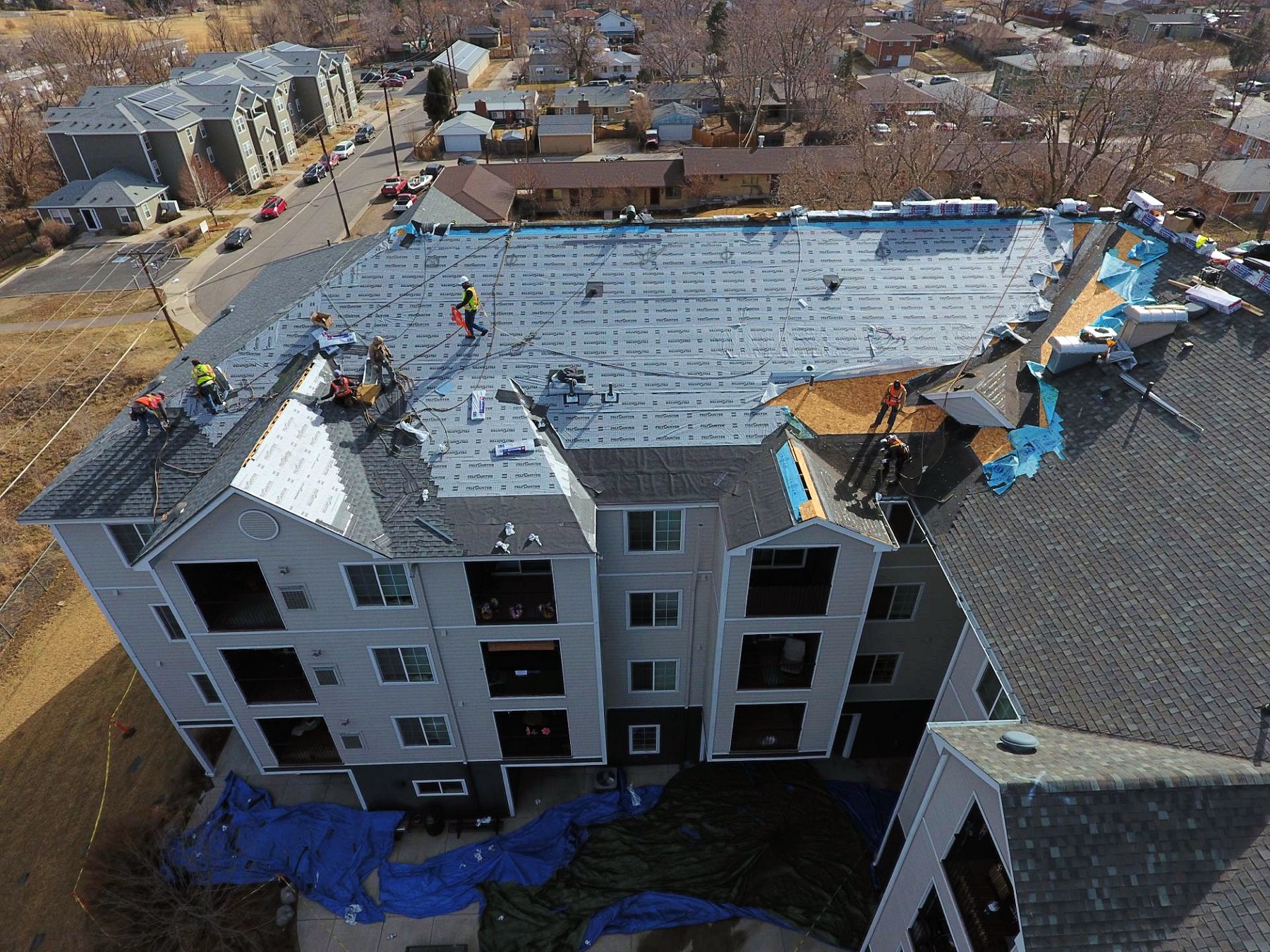 Multi-family commercial roof replacement aerial — apartment re-roof in progress Texas