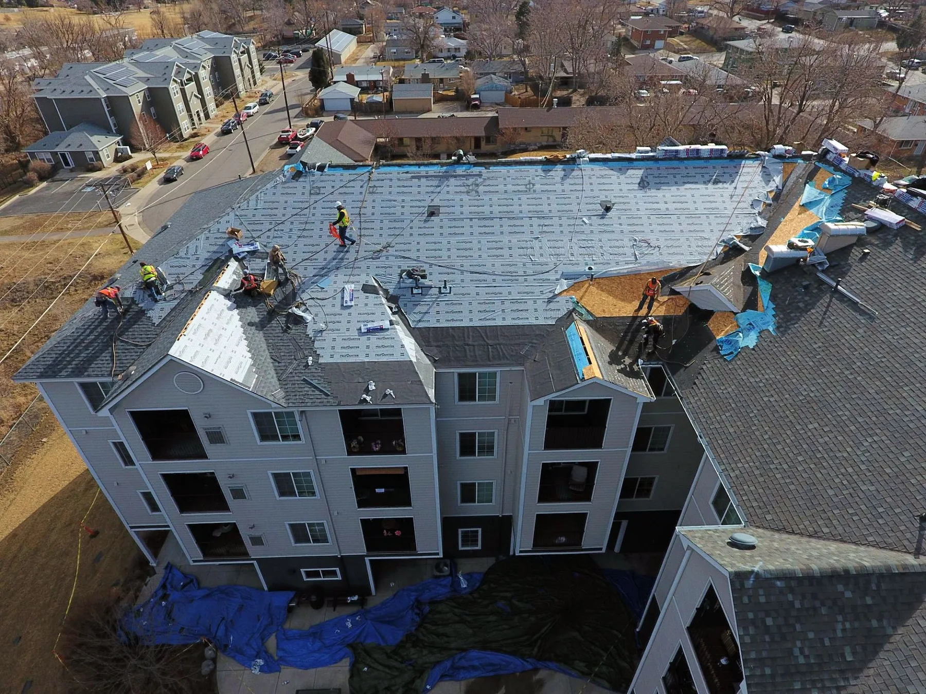 Multi-family commercial roof replacement aerial — apartment re-roof in progress Texas